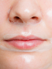 Fototapeta premium Close up woman in facial peel off mask.