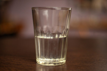 Faceted glass with water. Drink in a glass mug. Just water.