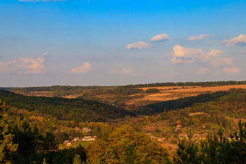 Picturesque autumn scenery with blue sky and colorful autumn trees on mountain hills