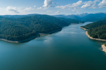 Aerial top view on a Fagaras mountains  surrounding Vidraru dam with a reservoir lake