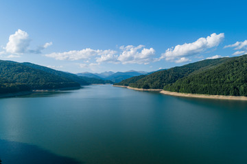 Aerial top view on a Fagaras mountains  surrounding Vidraru dam with a reservoir lake