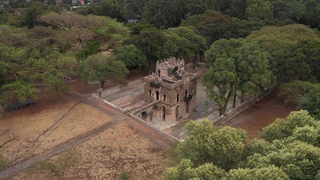 Descending drone flight of beautiful historic Fasilides' bath, landmark structure in Gondar, Ethiopia