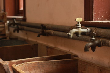 vintage antique laundry plumbing taps and wooden sinks in an old home, now museam, in Victoria, Australia