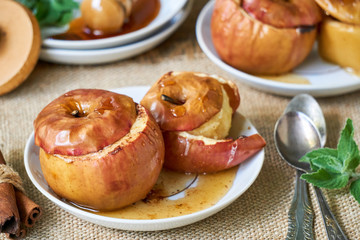 Baked apples with honey and cinnamon on a white plate