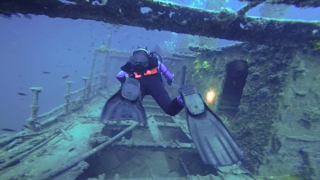 Scuba Diver Exploring A Large Shipwreck - Slow Motion