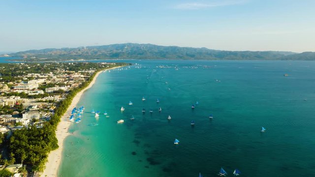Time lapse: Tropical white sand beach, hotels near the blue lagoon and corall reef. aerial view, Boracay, Philippines. Summer and travel vacation concept.