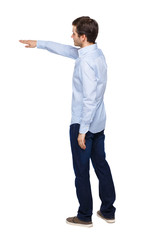 Back view of a man in jeans points his hand upwards.
