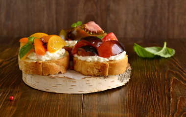 Bruschetta with soft cheese, tomatoes and basil, copy space