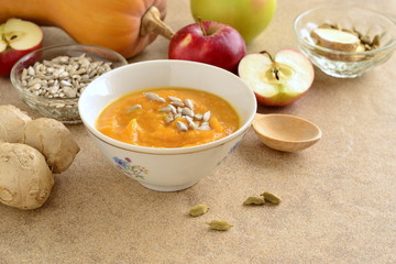 Roasted apple, pumpkin, ginger soup with cardamom, sprinkled with sunflower seeds, copy space