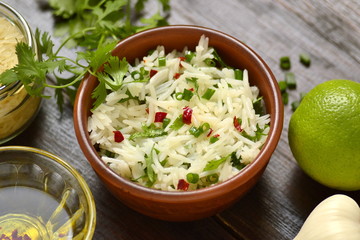Basmati rice with lime, cilantro and garlic in ceramic bowls