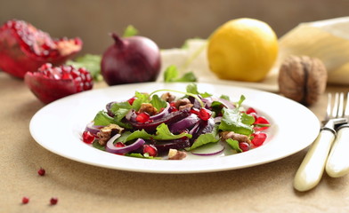 Beetroot salad with arugula, walnuts and pomegranate seeds