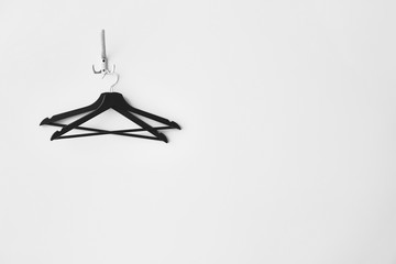 Clothes hangers on white wall