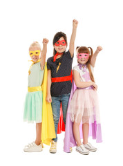 Fototapeta premium Cute little children dressed as superheroes on white background