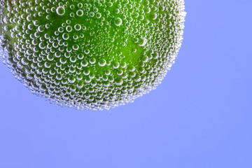 Ripe lime in water, closeup