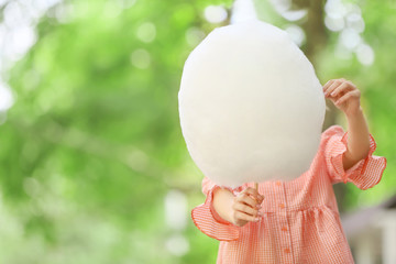 Woman with sweet cotton candy outdoors