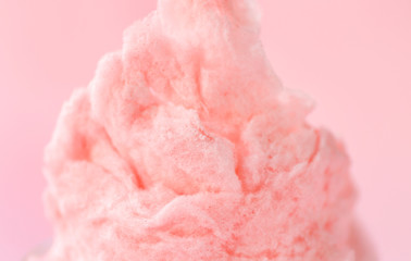 Tasty cotton candy on color background, closeup