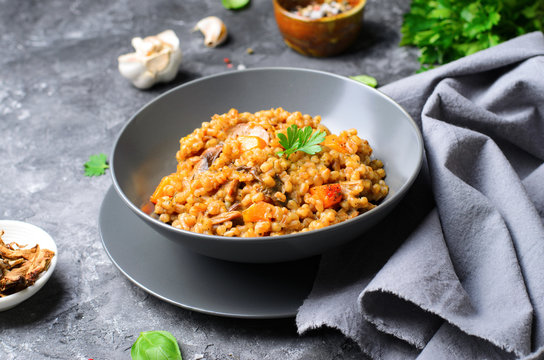 Spelt Pumpkin Mushroom Risotto On Grey Background, Vegetarian Meal