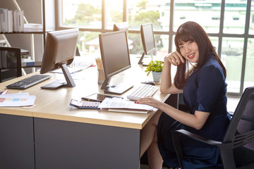 Obraz premium Beautiful young staff sitting at the office desk