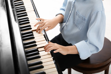 Child playing grand piano at the concert