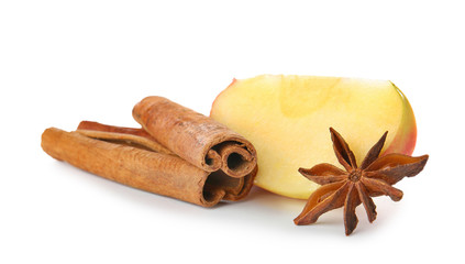 Fresh apple with cinnamon and anise on white background
