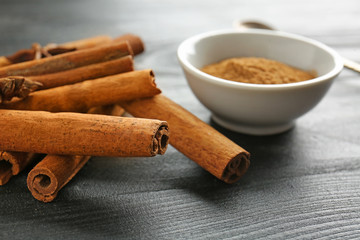 Aromatic cinnamon on dark wooden background