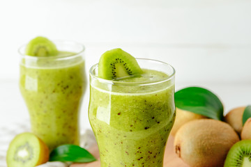 Glass of tasty kiwi smoothie on table, closeup