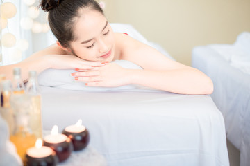 Young healthy asian woman lying relax in spa salon.Traditional Thai oriental aromatherapy and Massage beauty treatments.Recreation vitality wellness wellbeing resort hotel lifestyle leisure.copyspace