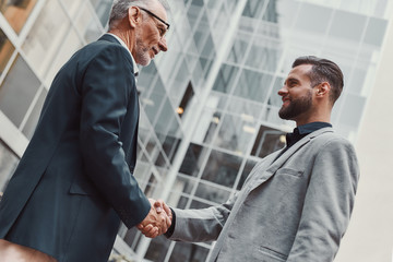 It's a pleasure to work with you. Businesspeople shaking hands before business lunch