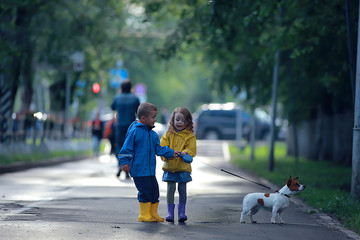 Obraz premium children dog autumn / two children, a boy and a girl walking with a small dog in the autumn park