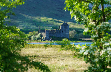 Kilchurn Castle , in the care of Historic Environment Scotland , is a ruined structure on a rocky peninsula at Loch Awe in twilight , Argyll and Bute, Scotland