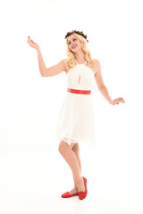 Fototapeta premium full length portrait of blonde girl wearing a white dress and flower crown. Standing pose, isolated against a white studio background.