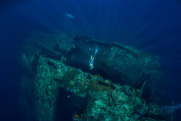 Freediver man dive underwater at shipwreck. Freediving in ocean