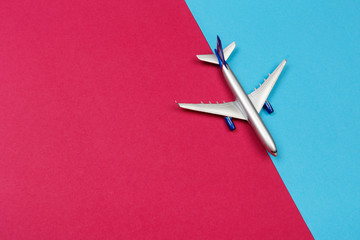 top view photo of toy airplane over color  background . travel concept .