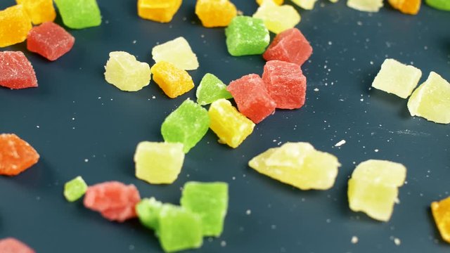Nice sweet jelly candy with shugar on dark surface. Close up of colour food.
