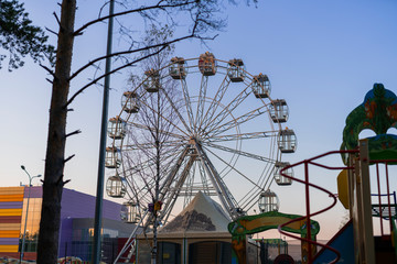 Ferris wheel against the background of the summer sky