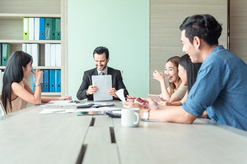 Teamwork business concept .Start up business people in modern office, working together having success. Multiethnic start-up business team on meeting in modern bright office interior brainstorming