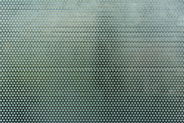 Background sheet of black metal steel of circular holes. Seamless surface stainless steel pattern design texture.