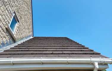 A small Tiled Pitch Roof on a new build house in Menston, Yorkshire, with PVC Guttering, Sofits and Lead Flashing. © Julian