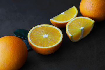 Orange citrus fruit on a stone table. Orange background.