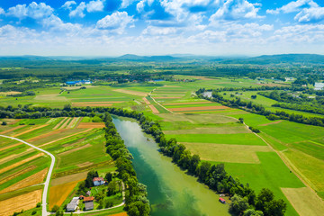 Fototapeta na wymiar Rural countryside landscape in Croatia, confluence of Korana and Kupa rivers between agriculture fields and villages, panoramic view from drone 
