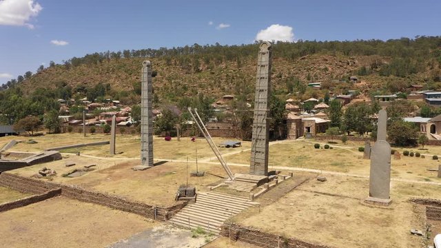 Rotating drone shot flying around famous obelisk towers in Aksum, tourism in Ethiopia