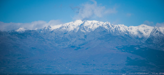 View of the mountains on a clear winter day where the blue sky and mountains predominate