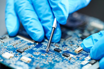 Asian Technician repairing micro circuit main board computer electronic technology : hardware, mobile phone, upgrade, cleaning concept.    