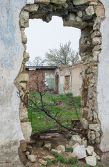Luhansk People's Republic. A breach in the wall of an abandoned building.