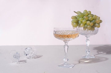 Beautiful crystal glasses with green grapes minimalistyc composition