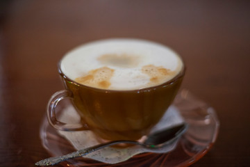 Cup with cappuccino. Coffee in the morning. A cup of strong coffee with foam.