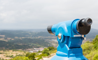 Tower viewer or tourist telescope with magnificent views and space for copy on the left.