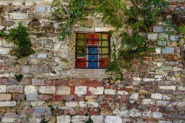 Brick stone wall and colorful window in street of Balat in Istanbul