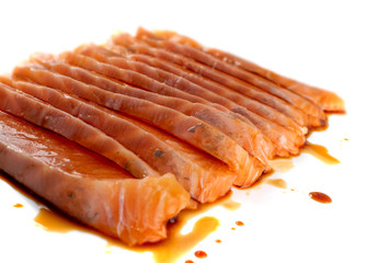 Thin Slices of Raw Salmon Fillet Isolated on White Background