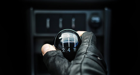 Gear lever. Manual Transmission. Hand on the gear shift in the car.